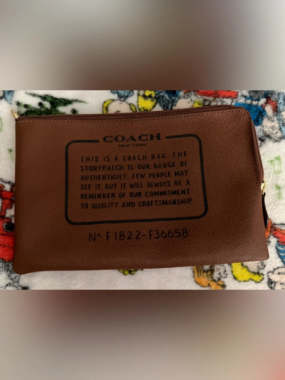Coach Brown Leather Wrist Zip Pouch with Creed in Black Logo Print. Wrist Strap.